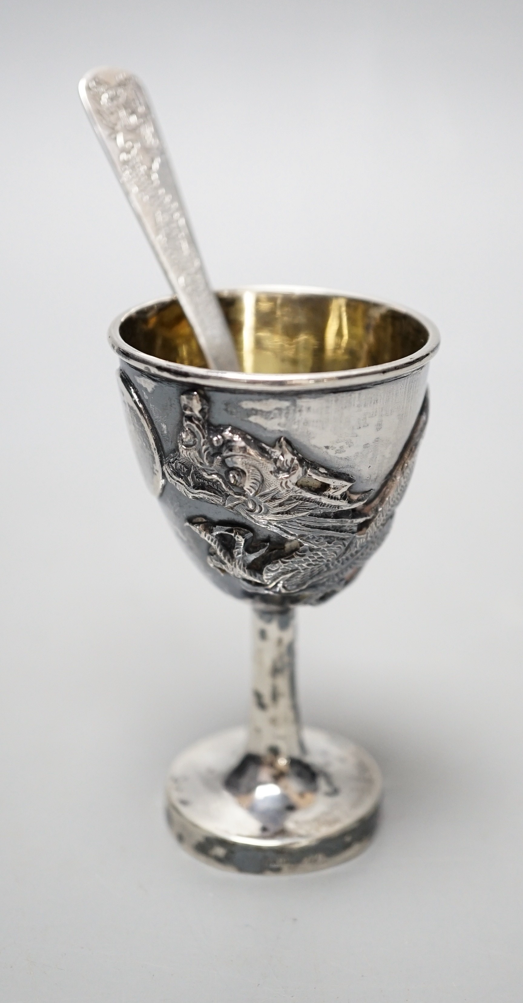 An early 20th century Chinese Export white metal dragon ‘egg’ cup and spoon, by Zee Shun, cup 76mm.